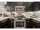 Close-up of kitchen with stainless steel oven, quartz countertops, and sleek black cabinets at 1418 Dresden Ne Dr # 355, Atlanta, GA 30319