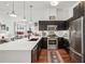 Bright kitchen featuring stainless steel appliances, black cabinetry, and a white countertop island at 1418 Dresden Ne Dr # 355, Atlanta, GA 30319