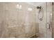 Contemporary shower with neutral stone tiles, a rainfall showerhead, and a glass door at 1418 Dresden Ne Dr # 355, Atlanta, GA 30319