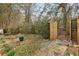 Backyard showcasing a gated entrance, mature landscaping, and room for outdoor activities at 172 Sweet Branch Ct, Grayson, GA 30017