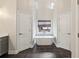 Bathroom featuring a standalone tub between two doorways, dark tile floor and high ceilings at 172 Sweet Branch Ct, Grayson, GA 30017