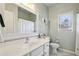 Bathroom with white vanity, framed mirror, and window providing natural light at 172 Sweet Branch Ct, Grayson, GA 30017