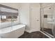 Contemporary bathroom featuring a standalone tub, glass enclosed shower and a window at 172 Sweet Branch Ct, Grayson, GA 30017