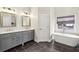 Modern bathroom with a double vanity, soaking tub, and neutral color palette at 172 Sweet Branch Ct, Grayson, GA 30017