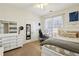 Cozy bedroom with a white dresser and an accent pillow that reads 