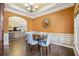 Elegant dining room with modern table, blue chairs, hardwood floors and decorative mirror, perfect for entertaining at 172 Sweet Branch Ct, Grayson, GA 30017