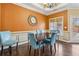 Cozy dining room with hardwood floors, wainscoting, and a stylish round mirror at 172 Sweet Branch Ct, Grayson, GA 30017