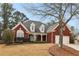 Charming two-story brick home with a well-manicured front yard and attached two-car garage, showcasing classic curb appeal at 172 Sweet Branch Ct, Grayson, GA 30017