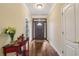 Bright foyer featuring hardwood floors, a decorative table with flowers, and a front door with decorative glass at 172 Sweet Branch Ct, Grayson, GA 30017