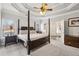 Spacious main bedroom featuring a four-poster bed, tray ceiling, and access to the ensuite bath at 172 Sweet Branch Ct, Grayson, GA 30017