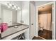 Bathroom vanity with granite counters, framed mirror, and access to the shower and toilet at 3655 Habersham Ne Rd # 227, Atlanta, GA 30305