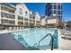 Community pool and sundeck with lounge seating, and residential buildings in the background at 3655 Habersham Ne Rd # 227, Atlanta, GA 30305