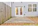 Back patio with concrete slab and wooden fence at 6356 Kennonbriar Ct, Lithonia, GA 30058