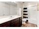 Bathroom featuring a dark vanity, a modern sink, a shower with a stylish curtain, and a toilet at 6356 Kennonbriar Ct, Lithonia, GA 30058