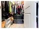 Walk in closet with lots of clothes, shoe organizers, and storage containers, offering ample space at 6356 Kennonbriar Ct, Lithonia, GA 30058