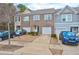 Townhome exterior showcasing brick facade, attached garages, and well-manicured landscaping at 6356 Kennonbriar Ct, Lithonia, GA 30058