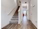 Hallway features hardwood floors, a carpeted staircase, and access to living spaces at 6356 Kennonbriar Ct, Lithonia, GA 30058