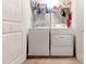 Functional laundry room with a washer, a dryer, storage, and neutral-toned flooring at 6356 Kennonbriar Ct, Lithonia, GA 30058