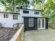 A spacious back deck featuring double doors, outdoor lighting, and a wooden railing at 1564 Bubbling Creek Rd, Brookhaven, GA 30319