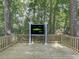 Outdoor entertainment deck with a built-in TV and a lovely wooded view at 1564 Bubbling Creek Rd, Brookhaven, GA 30319