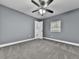 Neutral bedroom with soft carpet, a ceiling fan, and an ensuite bathroom for added convenience at 1564 Bubbling Creek Rd, Brookhaven, GA 30319