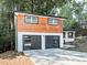 A stylish home featuring a two-car garage with modern doors and unique cedar plank accents at 1564 Bubbling Creek Rd, Brookhaven, GA 30319