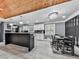 Bright eat-in kitchen with a wood ceiling, white cabinets, and modern black island at 1564 Bubbling Creek Rd, Brookhaven, GA 30319