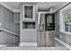 Modern kitchen area with stainless steel refrigerator, wine storage, and contemporary design at 1564 Bubbling Creek Rd, Brookhaven, GA 30319