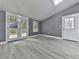 Bright living room with wood-look flooring, skylight, and doors to a small deck at 1564 Bubbling Creek Rd, Brookhaven, GA 30319