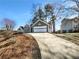 Gray home featuring an attached garage and a long concrete driveway at 1831 Killarney Sw Dr, Marietta, GA 30008