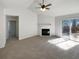 Bright living room featuring a fireplace, a ceiling fan, and sliding door access at 1831 Killarney Sw Dr, Marietta, GA 30008