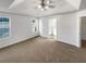 Main bedroom featuring a ceiling fan, an ensuite bathroom, and neutral paint at 1831 Killarney Sw Dr, Marietta, GA 30008