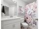 Bathroom featuring a vanity with marble countertop and floral shower curtain, combining style and functionality at 3037 Ferrington Way, Smyrna, GA 30080