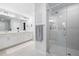 Bright bathroom featuring double sinks, quartz countertops, and a glass-enclosed shower at 3037 Ferrington Way, Smyrna, GA 30080