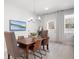 Dining room area with modern lighting, hardwood floors, and a picturesque view at 3037 Ferrington Way, Smyrna, GA 30080