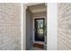 Inviting front entrance with a black front door, decorative columns and 'Home Sweet Home' doormat at 3037 Ferrington Way, Smyrna, GA 30080