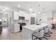 Open white kitchen featuring an island with bar seating, stainless steel appliances, and gray accents at 3037 Ferrington Way, Smyrna, GA 30080