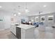 Open-concept kitchen with a large center island, stainless steel appliances, and pendant lighting at 3037 Ferrington Way, Smyrna, GA 30080