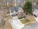 Aerial shot showcasing a beautiful home, mature trees, a well-kept yard, and a driveway at 3510 Estates Landing Nw Dr, Kennesaw, GA 30144