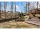 Large backyard featuring a multilevel patio and deck surrounded by mature trees at 3510 Estates Landing Nw Dr, Kennesaw, GA 30144