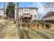 A view of a home's backyard featuring a patio, elevated deck, and landscaping at 3510 Estates Landing Nw Dr, Kennesaw, GA 30144