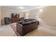 Basement living area features leather sofas, a large rug, and neutral walls at 3510 Estates Landing Nw Dr, Kennesaw, GA 30144