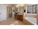 Bathroom featuring a glass-enclosed shower, soaking tub, and a double sink vanity at 3510 Estates Landing Nw Dr, Kennesaw, GA 30144