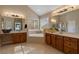 Bright bathroom with double sink vanity, soaking tub under a window, and neutral tile flooring at 3510 Estates Landing Nw Dr, Kennesaw, GA 30144