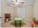 Bright bedroom featuring a ceiling fan, closet, neutral carpeting, and table with chairs at 3510 Estates Landing Nw Dr, Kennesaw, GA 30144