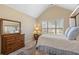 Cozy bedroom with vaulted ceilings, neutral walls, and a window bringing in natural light at 3510 Estates Landing Nw Dr, Kennesaw, GA 30144