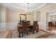 Formal dining room with tray ceiling, chandelier, and wainscoting accents for elegant meals at 3510 Estates Landing Nw Dr, Kennesaw, GA 30144