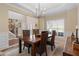 Inviting dining area showcasing hardwood floors, natural light, wainscoting, and stairs to the second level at 3510 Estates Landing Nw Dr, Kennesaw, GA 30144