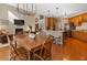 Spacious kitchen and living area, featuring stainless steel appliances, a breakfast bar, and a cozy fireplace at 3510 Estates Landing Nw Dr, Kennesaw, GA 30144