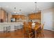 Eat-in kitchen with stainless steel appliances, white countertops, wood cabinetry, and a view into the breakfast nook at 3510 Estates Landing Nw Dr, Kennesaw, GA 30144